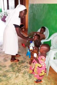 Sr. Josie and children in dispensary